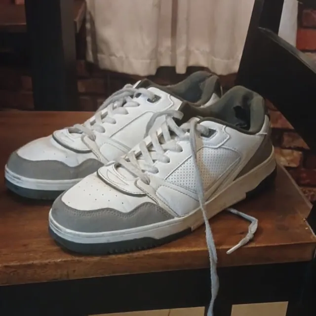 the sneakers as shot: dim room, cluttered