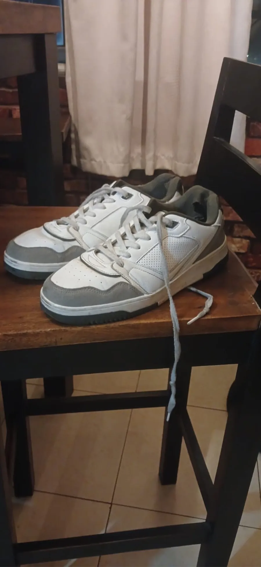 sneakers on a chair at home, phone camera